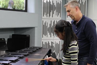 A student plays a xylophone