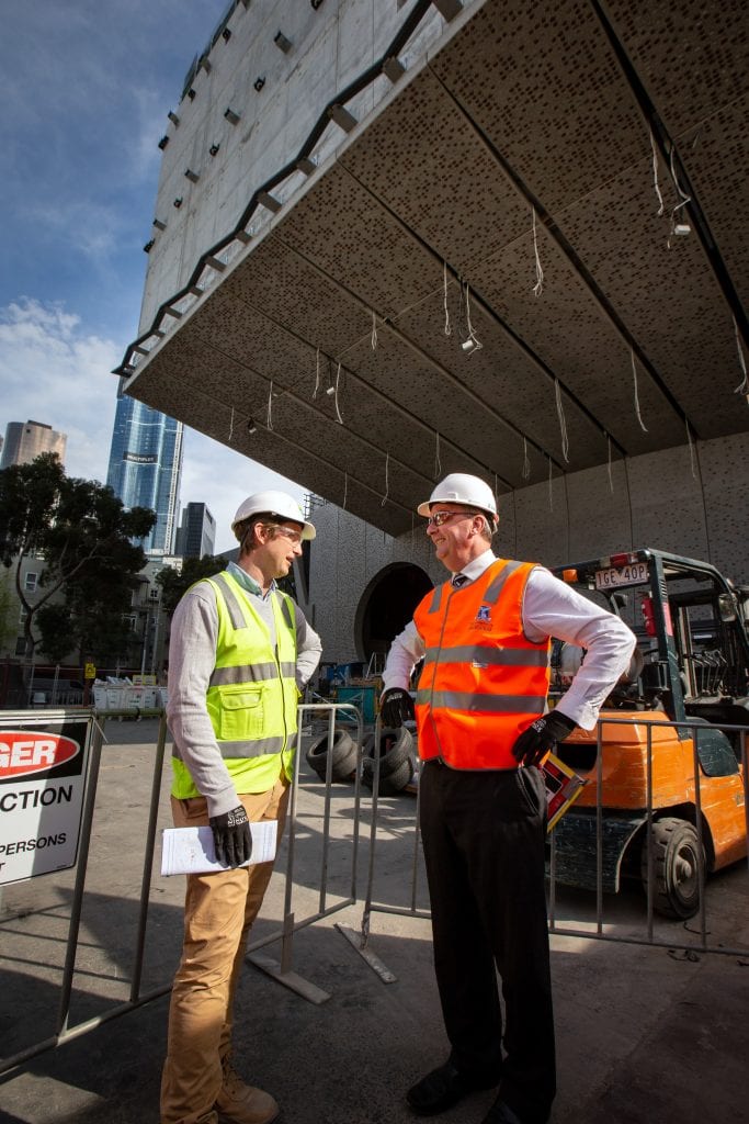 Lendlease Construction Manager Nat Gray and Victoria’s Minister for Creative Industries Martin Foley discuss The Ian Potter Southbank Centre under the building’s cantilever. By Sav Schulman.