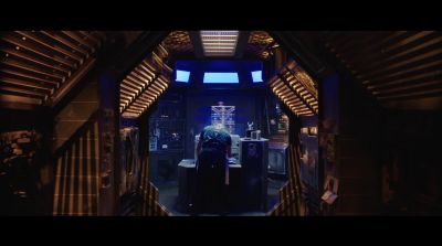 An actor stands on a spacecraft film set