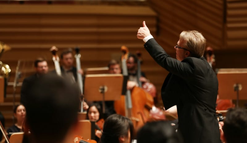 Conductor Richard Davis gives the thumbs up to the brass section in rehearsal at the Shanghai Symphony Hall. Photo by Chris P. Lim.