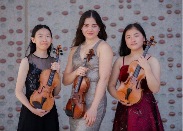 Jackie Wong, Leanne McGowan and Emily Su holding violins