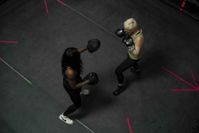 Two women stand in a boxing ring