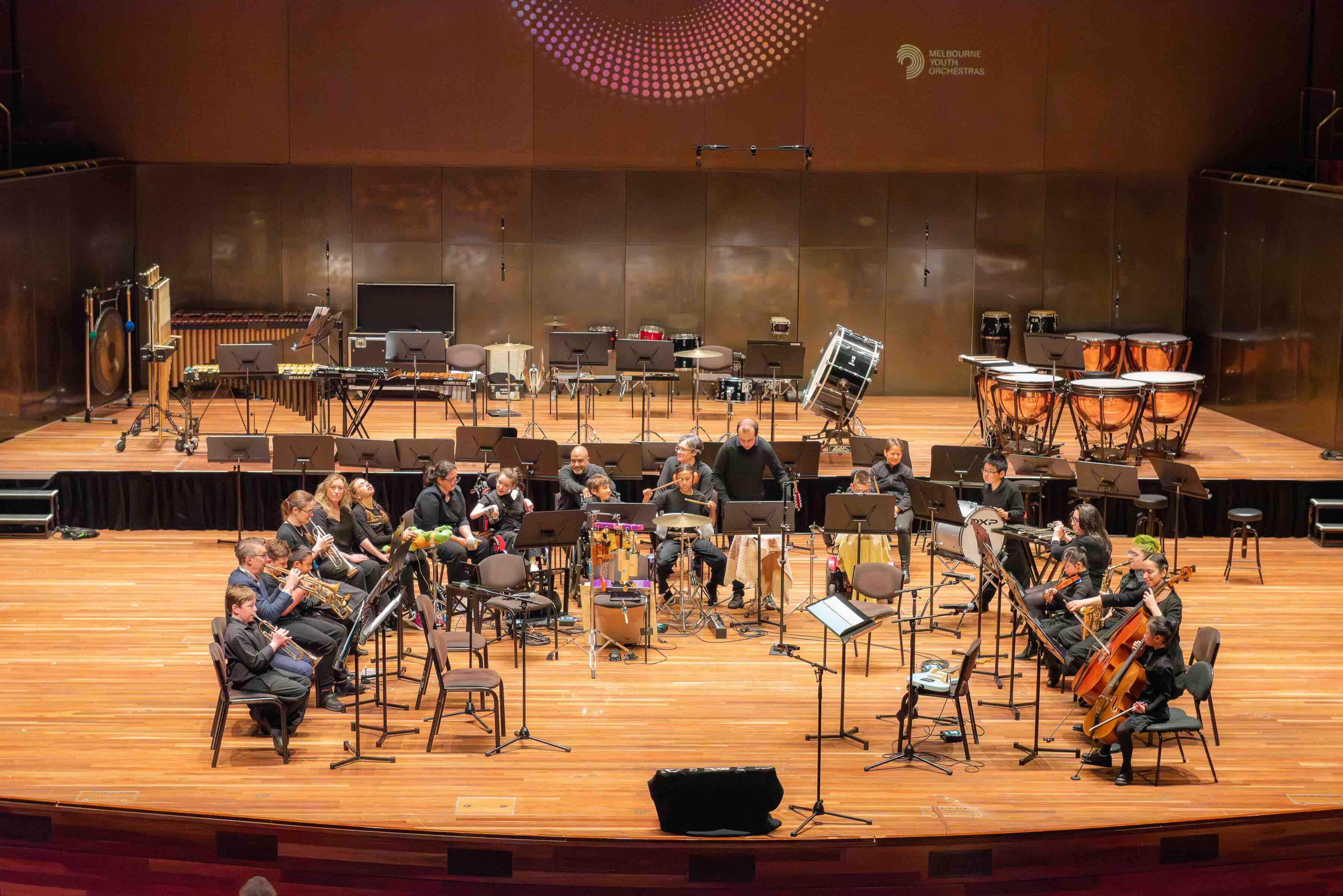 An orchestra performs on a stage