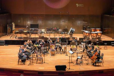 An orchestra performs on a stage