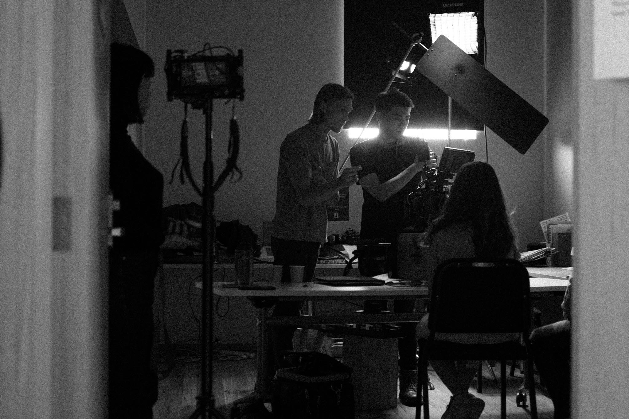 Black and white image of behind the scenes of a film