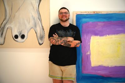 Nicholas Currie with grad show paintings