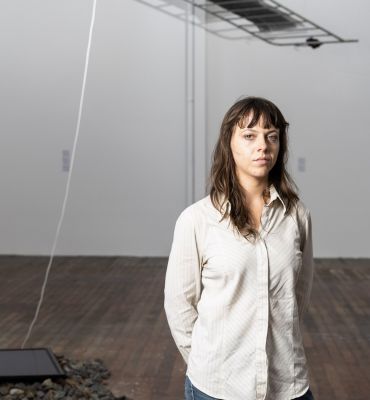 Artist stands in studio