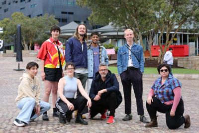 Student musicians and artists taking over Fed Square on NYE. L - R: Leon Tran, Quinn Franks, Emily White, Dean Elliot, Joshuah Ephraums, Mike Callander, Serge Balaam, and Di Drew. Image credit: Timothy Walsh 