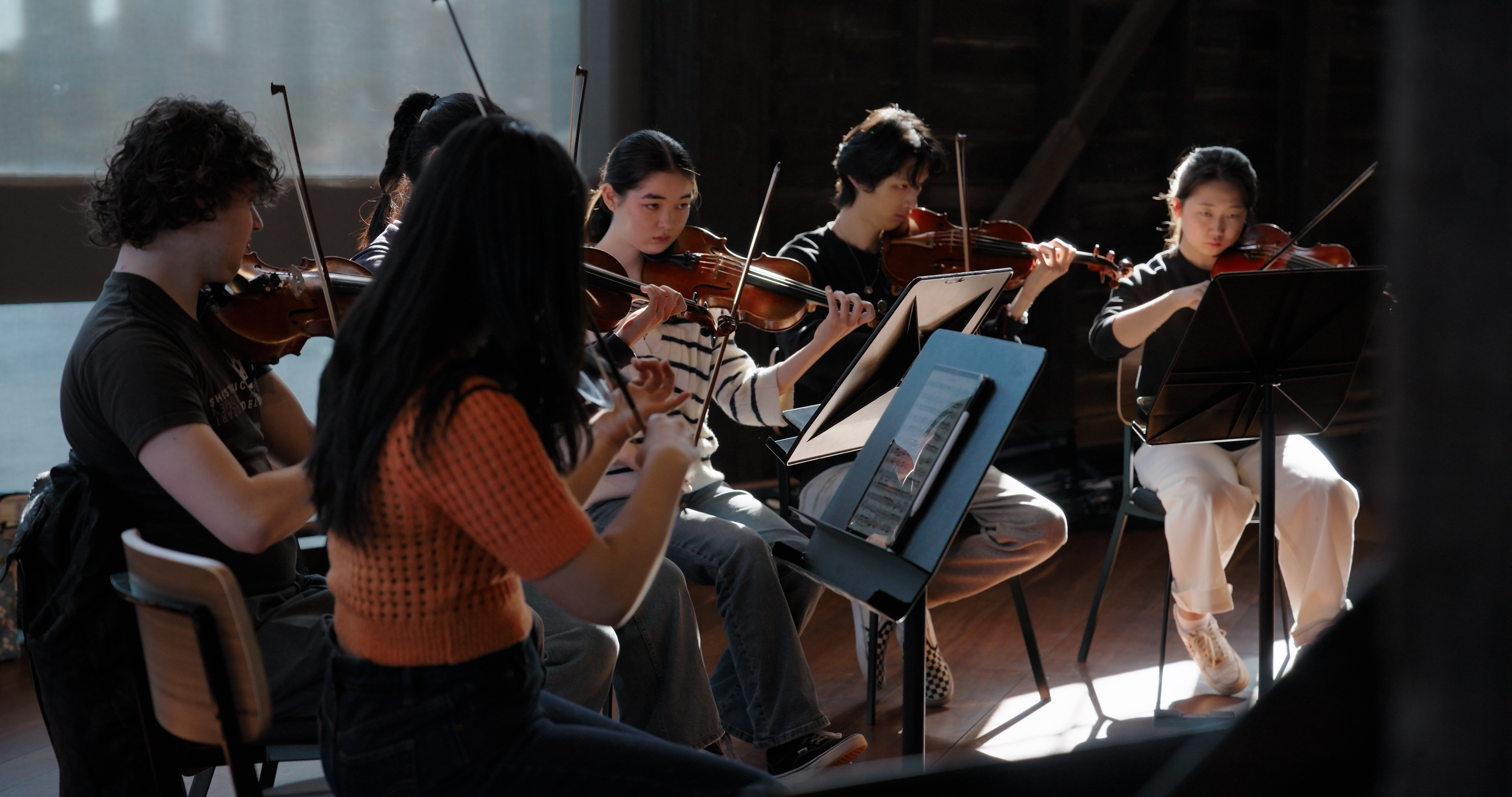 Musicians playing in a bright open space