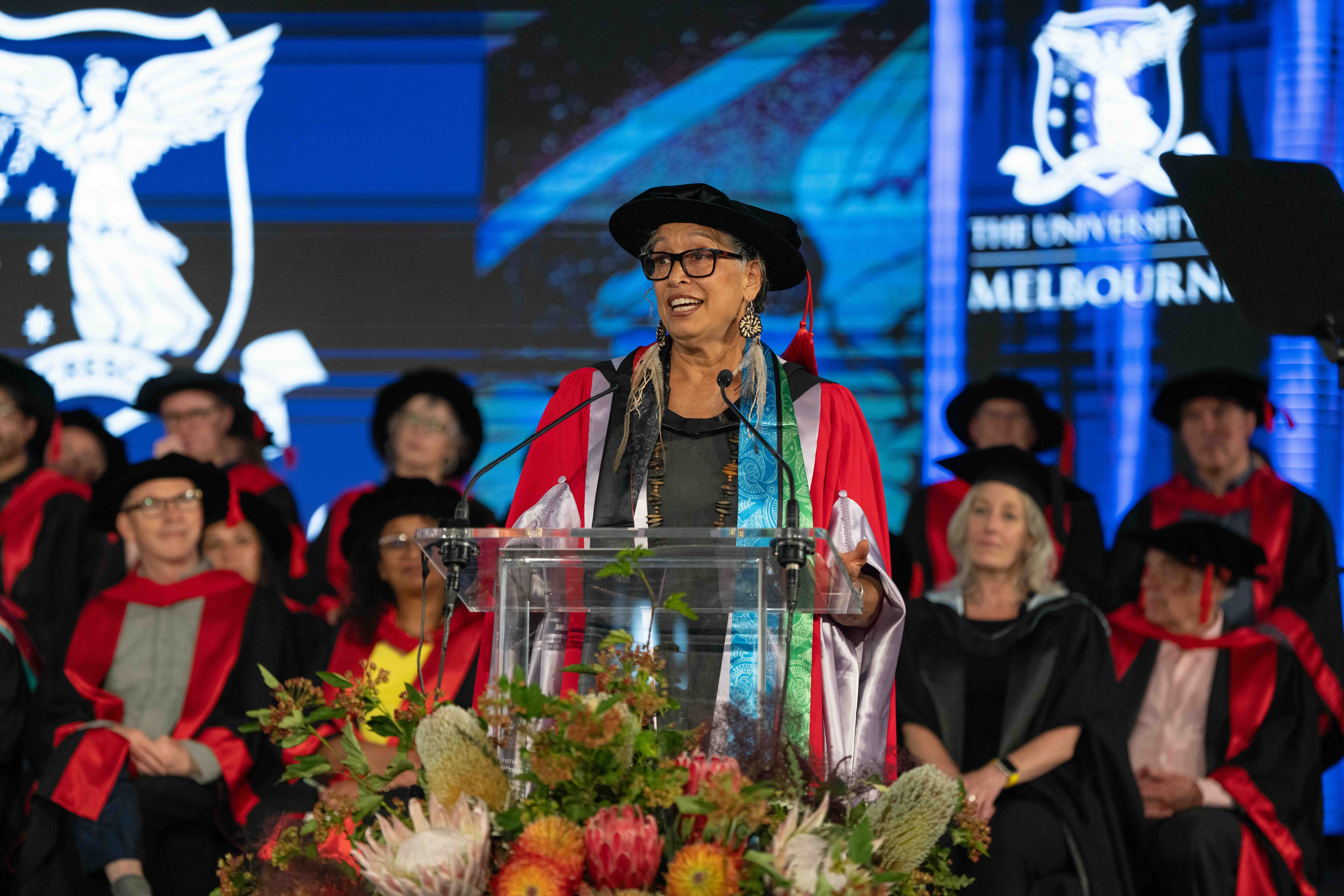 A woman speaks at a graduation ceremony.