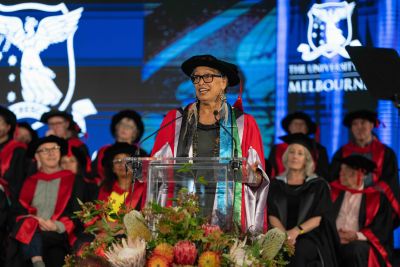 A woman speaks at a graduation ceremony.