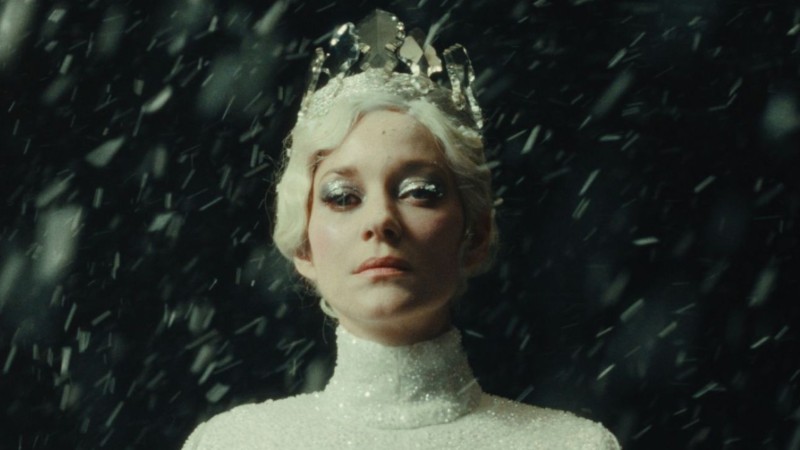 A stately woman wears a crown