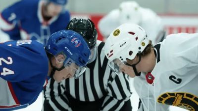 Close up of two ice hockey players going head to head on the hockey rink