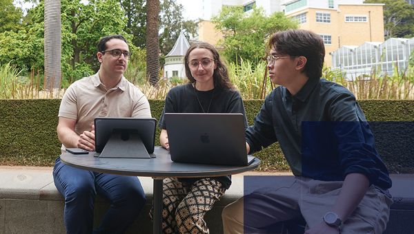 Students on laptops sitting outside